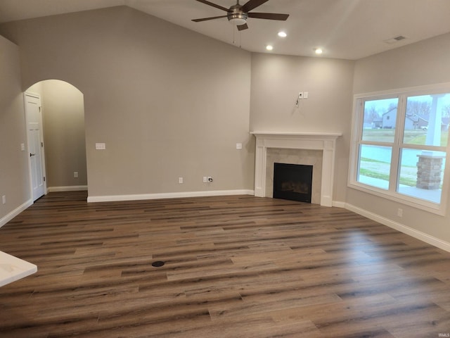 unfurnished living room featuring lofted ceiling, ceiling fan, and dark wood-type flooring