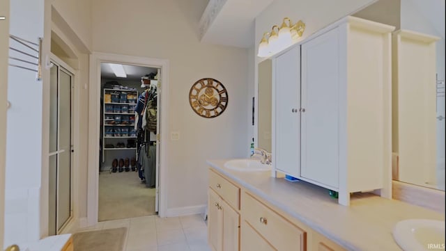 bathroom featuring tile patterned floors, vanity, and an enclosed shower