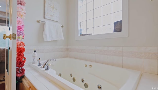 bathroom with tiled tub