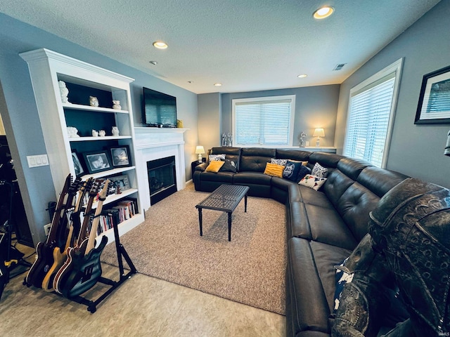 carpeted living room with a textured ceiling