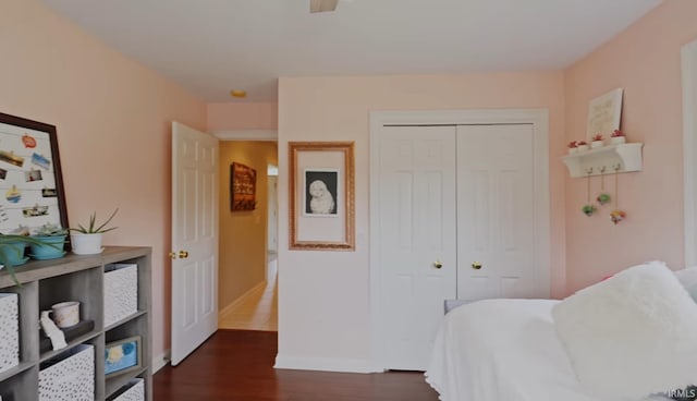 bedroom featuring dark hardwood / wood-style flooring and a closet