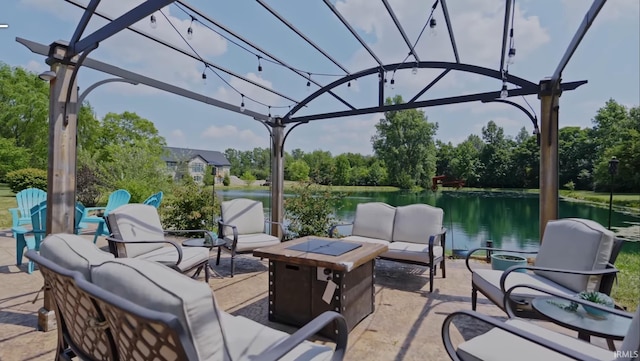 view of patio / terrace featuring a water view and an outdoor living space with a fire pit