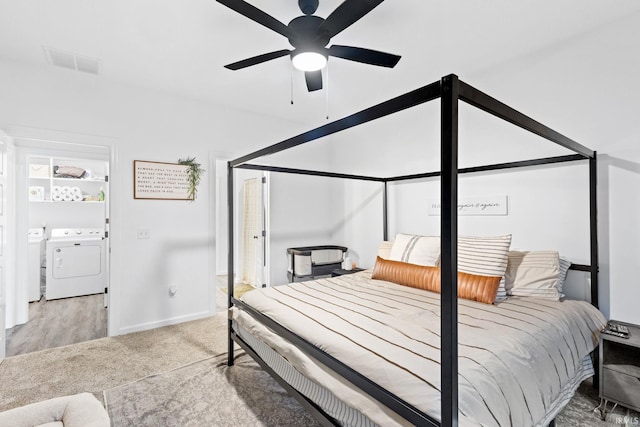 carpeted bedroom featuring washing machine and clothes dryer and ceiling fan