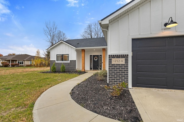 entrance to property with a yard and a garage