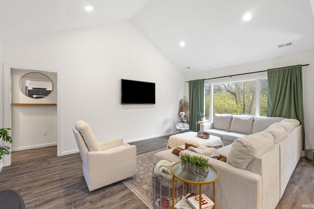 living room with dark hardwood / wood-style floors and high vaulted ceiling