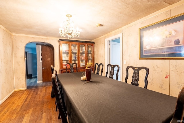 dining area featuring hardwood / wood-style floors and a notable chandelier