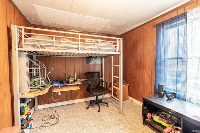 carpeted bedroom with wooden walls