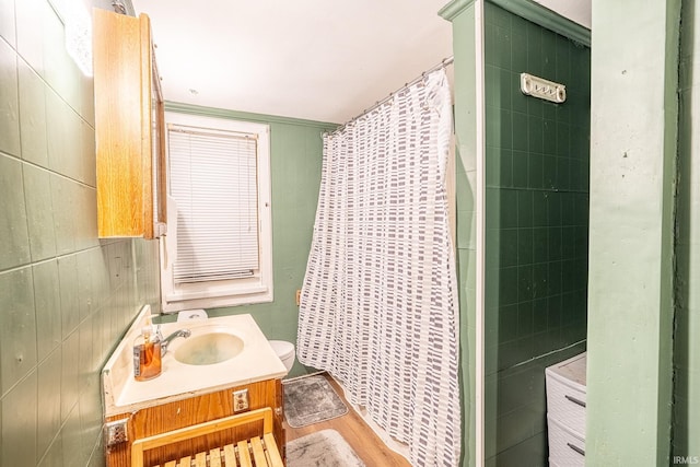 bathroom featuring a shower with curtain, vanity, wood-type flooring, and tile walls