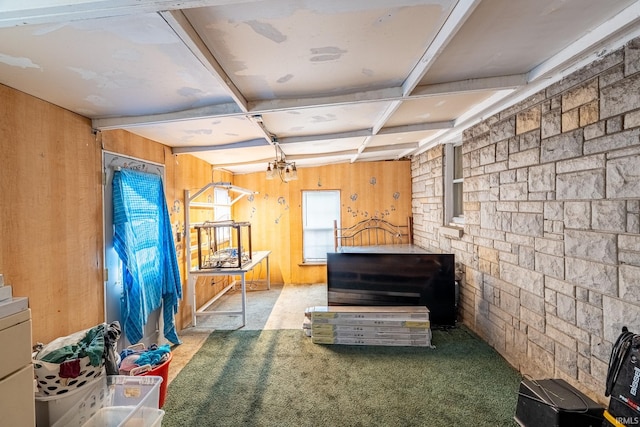 misc room with coffered ceiling, an inviting chandelier, wooden walls, carpet flooring, and beam ceiling