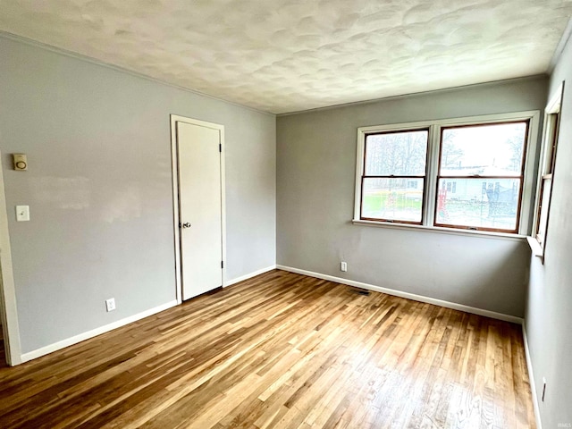 unfurnished room with light hardwood / wood-style flooring