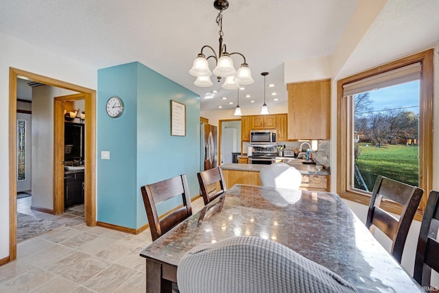 dining area with an inviting chandelier