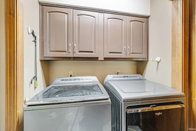 laundry area with cabinets and washer and clothes dryer