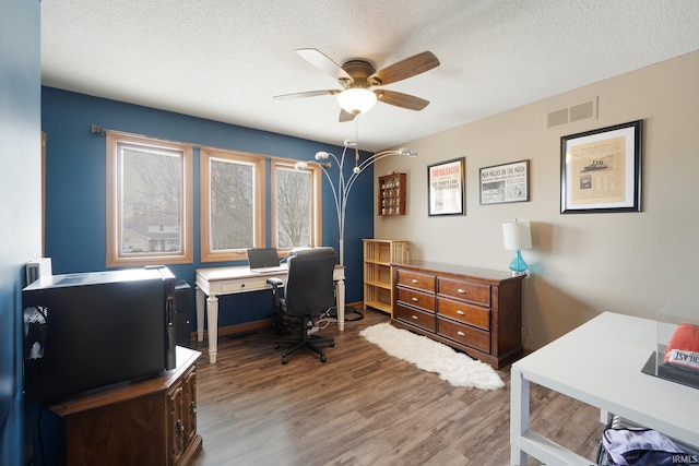 office space with a textured ceiling and dark wood-type flooring