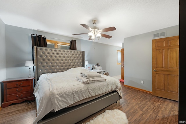 bedroom featuring ceiling fan and dark wood-type flooring