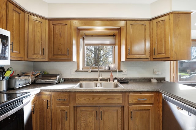 kitchen featuring dishwasher, range with electric stovetop, decorative backsplash, and sink