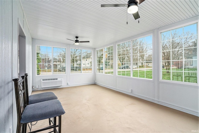 sunroom / solarium with a wall mounted air conditioner and ceiling fan