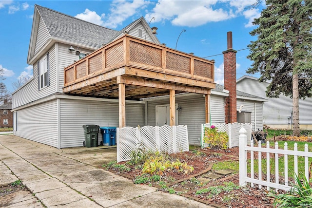 view of side of home with a deck