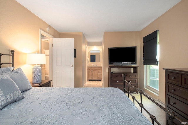 carpeted bedroom with ensuite bathroom