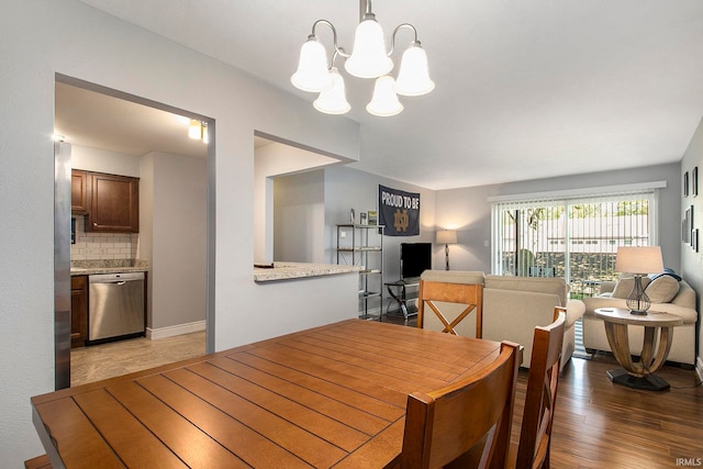 dining area with hardwood / wood-style floors and a notable chandelier