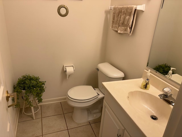 bathroom featuring tile patterned flooring, vanity, and toilet