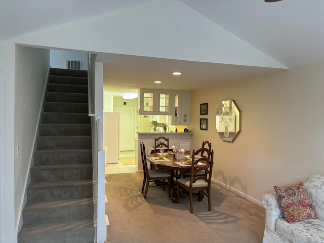 dining space featuring light colored carpet