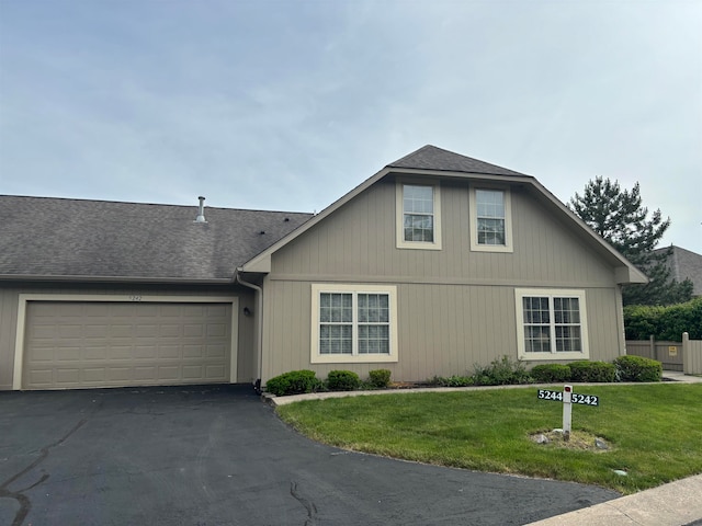 view of front of house featuring a garage and a front lawn