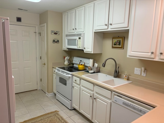 kitchen featuring white cabinetry, white appliances, sink, and light tile patterned floors