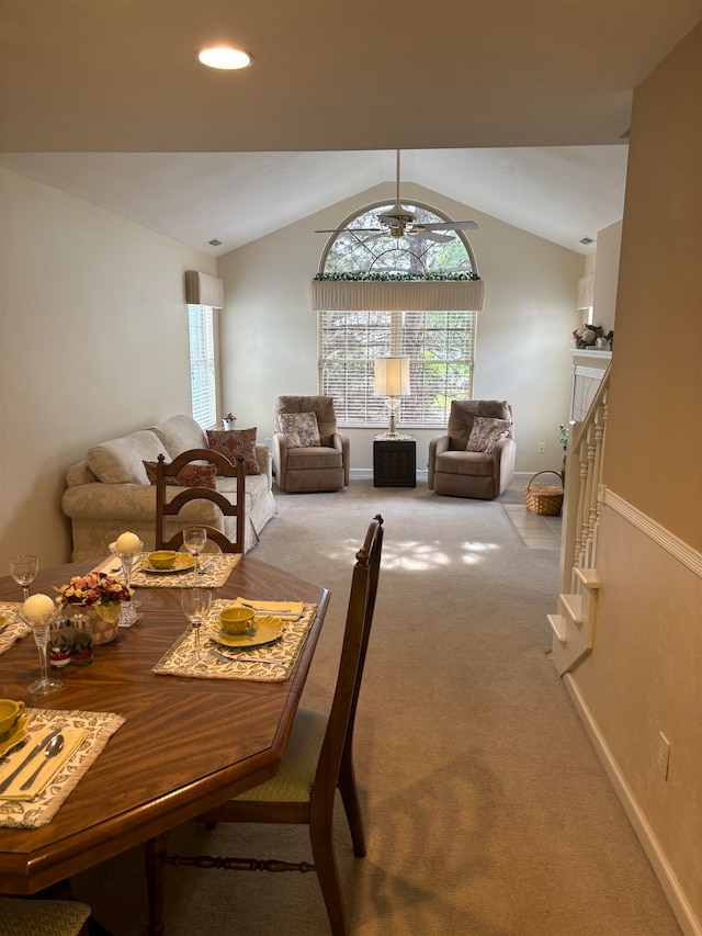 dining space featuring light carpet, ceiling fan, and lofted ceiling