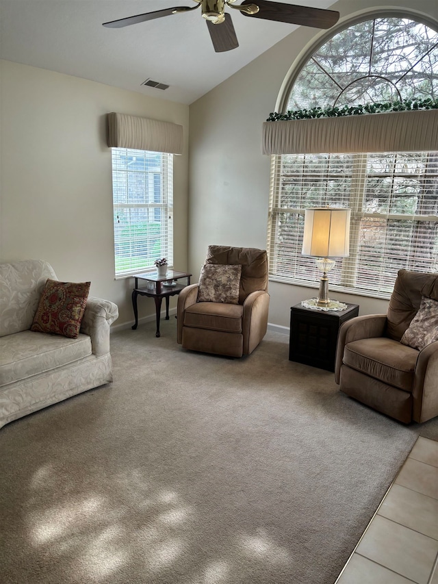 living room with carpet, plenty of natural light, lofted ceiling, and ceiling fan