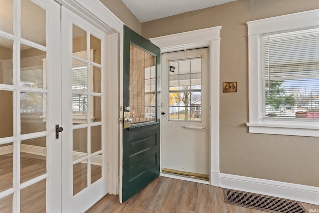 entryway with french doors and wood-type flooring