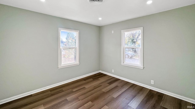 unfurnished room with dark hardwood / wood-style floors