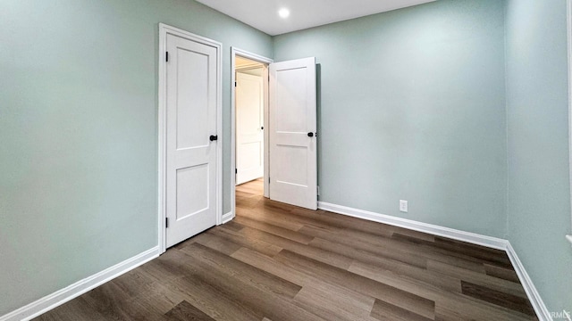 empty room featuring dark wood-type flooring