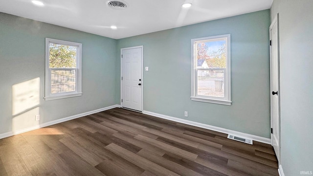 empty room with dark hardwood / wood-style flooring