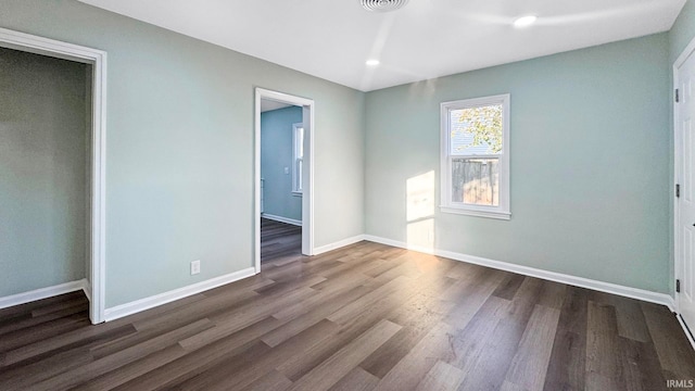 unfurnished bedroom with dark hardwood / wood-style flooring