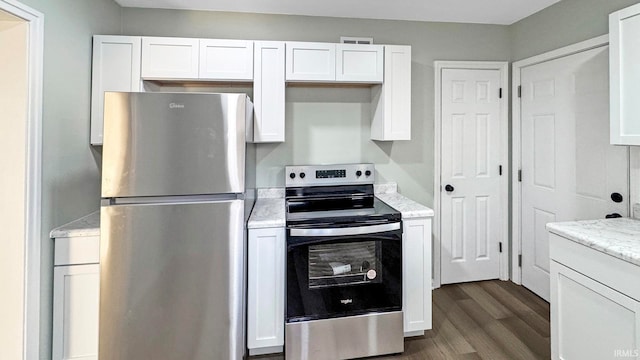 kitchen featuring light stone countertops, dark hardwood / wood-style flooring, stainless steel appliances, and white cabinetry