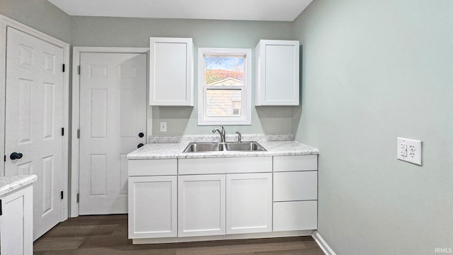 laundry area with sink and dark hardwood / wood-style floors