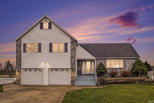 view of front facade featuring a yard and a garage