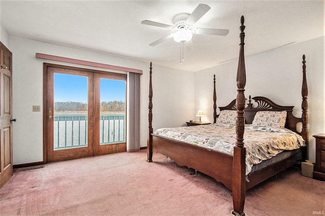 bedroom featuring carpet flooring, ceiling fan, a water view, and access to outside