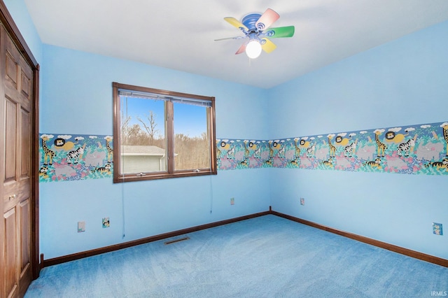 carpeted empty room with ceiling fan