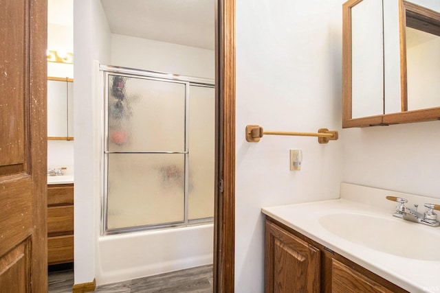 bathroom with vanity, shower / bath combination with glass door, and wood-type flooring