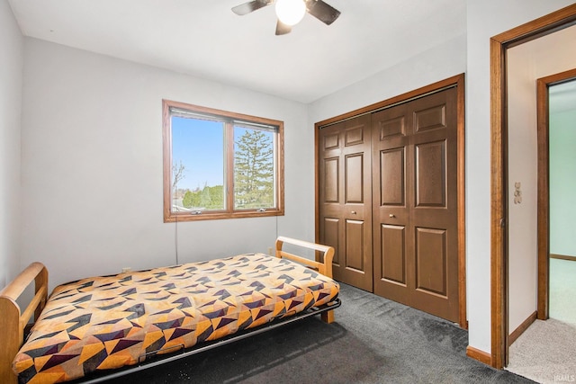 bedroom featuring ceiling fan, a closet, and dark colored carpet