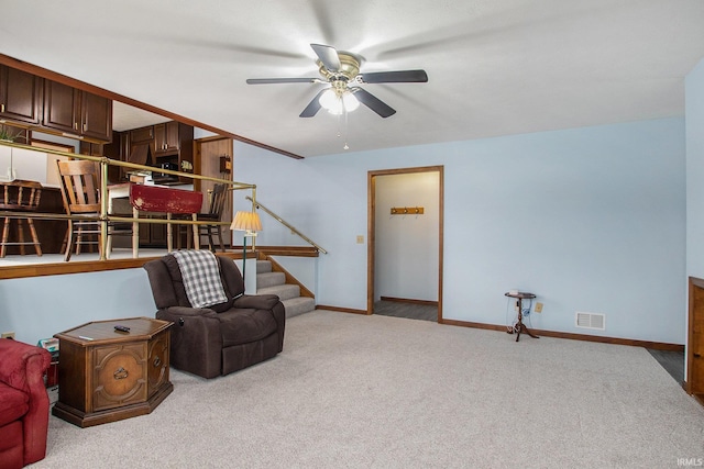 living area featuring ceiling fan and light colored carpet