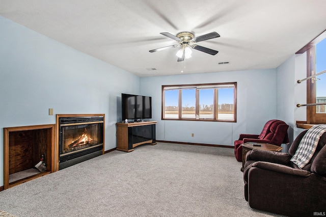 carpeted living room with ceiling fan