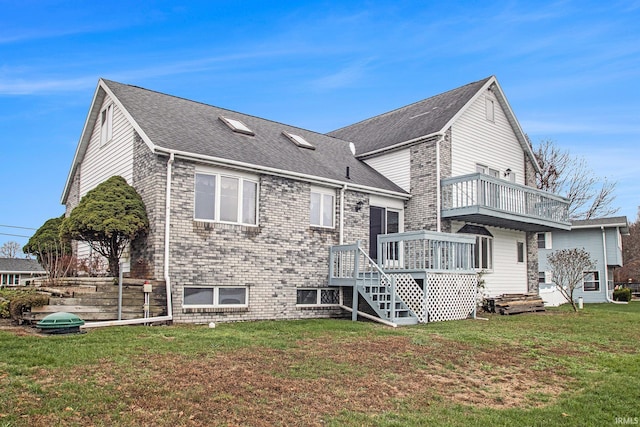 back of house featuring a balcony, a yard, and a wooden deck