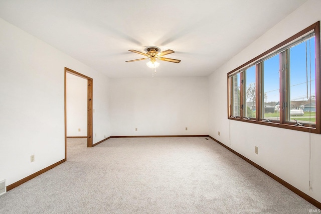 carpeted empty room featuring ceiling fan