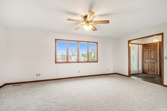 carpeted spare room featuring ceiling fan