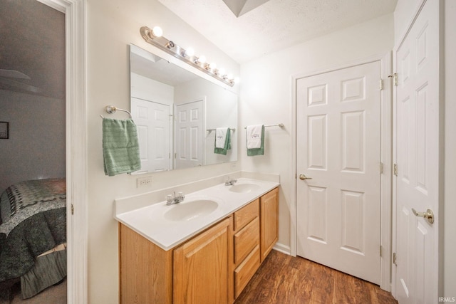 bathroom with vanity, a textured ceiling, and hardwood / wood-style flooring