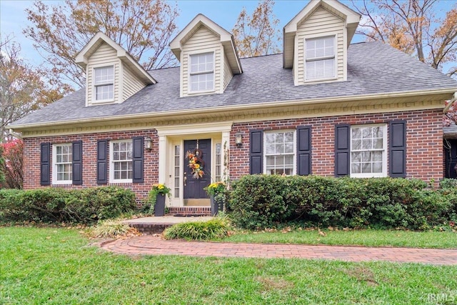 cape cod-style house with a front lawn