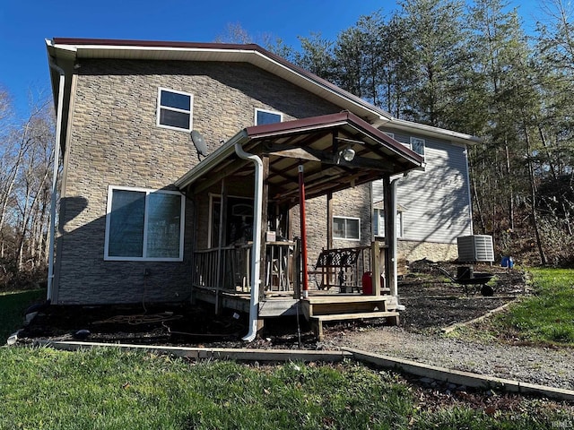 rear view of house featuring covered porch and central air condition unit