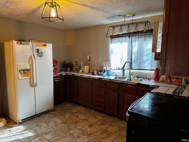 kitchen with sink, white fridge with ice dispenser, hanging light fixtures, and black / electric stove